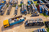 Rupganj ,Bangladesh - 06 September 2020: Aerial view of lorries loading oil barrels in a parking lot in Rupganj,Dhaka province,Bangladesh