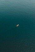Aerial view of a person canoeing into the sea in Cefalù,Sicily,Italy