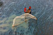 Badalgachhi,Bangladesh - 30 January 2021: Aerial view of fishermen on a canoe sailing the Jamuna river,Bangladesh