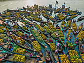 Bangladesh - 15 February 2023: Aerial view of floating market of seasonal fruits on the boats in Kaptai Lake,Rangamati,Bangladesh