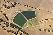 Aerial view of beautiful water treatment plant surrounded by green fields and trees,Birregurra,Australia