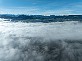 Aerial view of serene mountain landscape under a beautiful blue sky with clouds,Uerikon,Switzerland