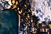 Aerial view of rocky coastline with crashing waves and dock,Cape Town,South Africa