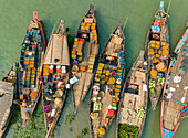 Aerial view of people trading with fruits and vegetables on boats along the river in Dhaka,Bangladesh