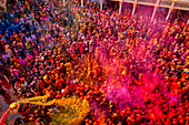 Nandgaon,India - 01 March 2023: Aerial view of people celebrating the holy colour festival at Shri And Baba Temple,Uttar Pradesh,India