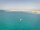 Aerial view of a couple kayaking in the middle of The world islands in Dubai,United Arab Emirates
