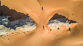 Aerial view of two persons walking in the desert of Sharjah,U.A.E