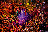 Nandgaon,India - 01 March 2023: Aerial view of people celebrating the holy colour festival at Shri And Baba Temple,Uttar Pradesh,India