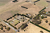 Luftaufnahme von schönem ländlichen Ackerland mit Feldern, Bäumen und einer Straße, Winchelsea, Victoria, Australien