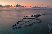 Aerial view of a beautiful luxury resort at sunset on Alifu Dhaalu Atoll in North Central Province in the middle of the Ocean,Alif ALif,Maldives
