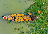 Aerial view of people trading with fruits and vegetables on boats along the river in Dhaka,Bangladesh