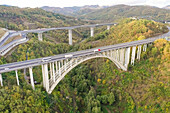 Aerial view of arch bridge crossing mountain region,Italy