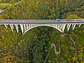 Aerial view of arch bridge crossing mountain region,Italy