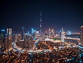 Aerial view of Dubai skyline with Burj Khalifa world's tallest skyscraper at night with Dubai creek in foreground,United Arab Emirates