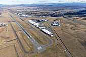 Aerial view of canberra airport with runway,buildings,fields,and roads,Pialligo,Australia