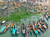 Aerial view of people trading with fruits and vegetables on boats along the river in Dhaka,Bangladesh