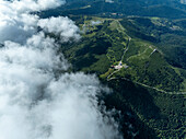 Aerial view of serene and majestic mountains surrounded by lush forests and expansive valleys under a tranquil sky,Lautenbachzell,France