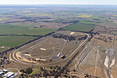 Luftaufnahme einer ausgedehnten Pferderennbahn, umgeben von schöner Landschaft und Ackerland, Melton, Australien