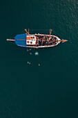 Aerial view of people jumping off the boat into the Mediterranean Sea in La Valletta,Malta