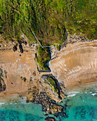 Aerial view of woodland steps down to Polstreath Beach with turquoise sea,Polstreath Beach,Mevagissey,Cornwall,United Kingdom