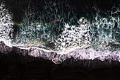 Aerial view of rough sandy beach with blue ocean waves,Wai`anapanapa State Park,Wai`anapanapa Black Sand Beach,Maui,United States
