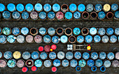 Aerial view of colourful clay urns for fish sauce production with a worker in a yellow hat,Ham Tien,Phan Thiet,Vietnam