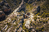Aerial view of the Roman aqueduct of Pena Cortada surrounded by monumental rocks and plants,Calles,Valencia,Spain