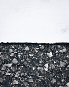 Aerial view of a contrast of asphalt and snow in a black and white abstract pattern,Newburgh,United States
