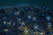 Aerial view of vibrant morning fish market with bustling activity on the beach,Tam Tien,Quang Nam,Vietnam