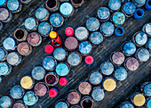 Aerial view of vibrant circles of clay urns and a worker with a yellow hat in a food production scene,Ham Tien,Vietnam