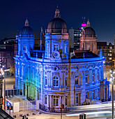 Aerial view of illuminated city hall and urban landscape at night with traffic and historic buildings,Hull,United Kingdom
