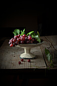 Still life with red grapes in an antique fruit bowl