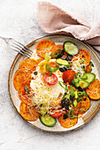 Sweet potato carpaccio with raw vegetables and alfalfa sprouts