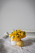 Still life with a bouquet of daffodils and decorative Easter egg