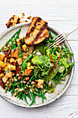 Grilled garden salad with beans and sun-dried tomatoes