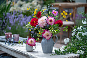 Blumenstrauß mit Dahlie, Mannstreu, Färberkamille und Zierapfel im Krug