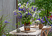 Bouquet with nettle-leaved bellflower, delphinium, true camomile, wild carrot, sprigs of climbing cucumber