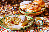Carnival doughnuts with apricot jam and icing sugar