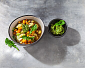 Vegetable and chickpea soup with dandelion pesto