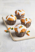 Carrot muffins with sugar icing and marzipan carrots