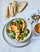 Lamb's lettuce with fried avocado slices wrapped in bacon