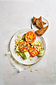 Tomato and egg rings on cucumber carpaccio