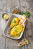 Chicken breast fillets with feta orange curry cream and naan