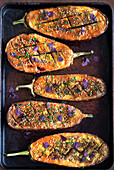 Miso-glazed aubergine halves with sesame seeds and flower decoration
