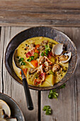 Creamy mussel soup with potatoes and vegetables
