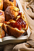 Doughnuts with jam, chocolate cream and vanilla cream