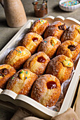 Doughnuts with jam, chocolate cream and vanilla cream