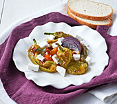Friggitelli in agrodolce with onions, cherry tomatoes and feta