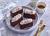 Chocolate liqueur cake slices with cream