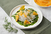 Fennel with orange strips on spinach sauce